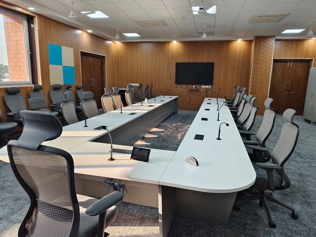 Large U-shaped conference hall with microphone setup