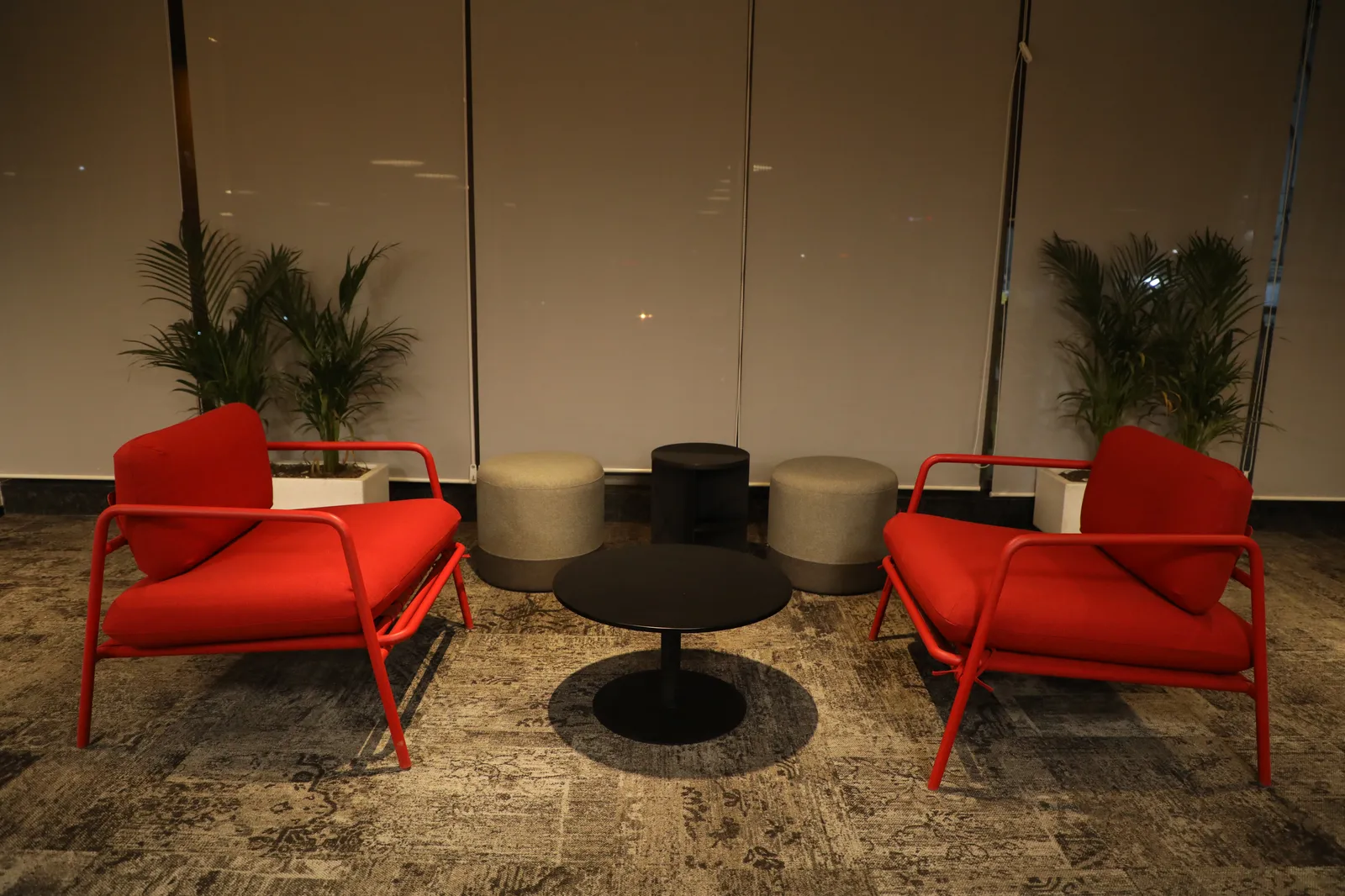 Modern breakout lounge with red accent chairs